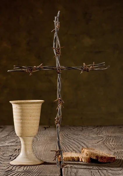 Chalice and bread on the wooden table — Stock Photo, Image