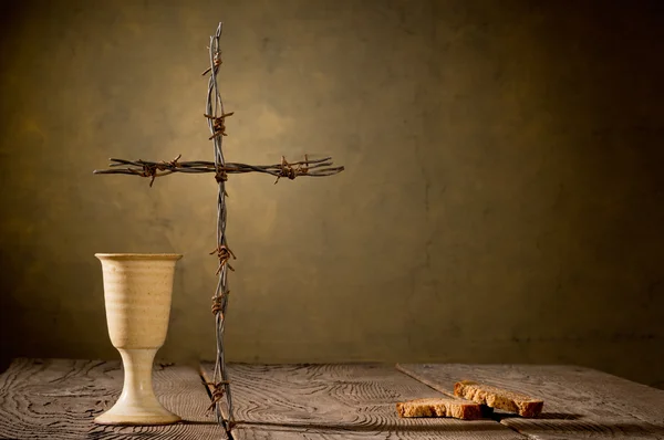 Chalice and bread on the wooden table — Stock Photo, Image