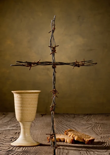 Chalice and bread on the wooden table — Stock Photo, Image