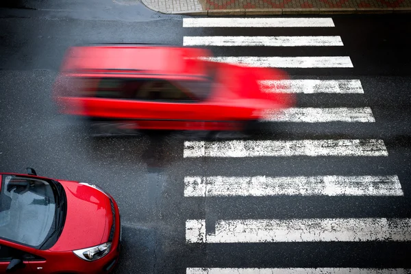 Dois carros vermelhos na travessia de pedestres — Fotografia de Stock