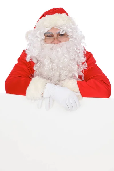 Santa Claus pointing on blank white wall, advertisement banner with copy space. Isolated on white background — Stock Photo, Image