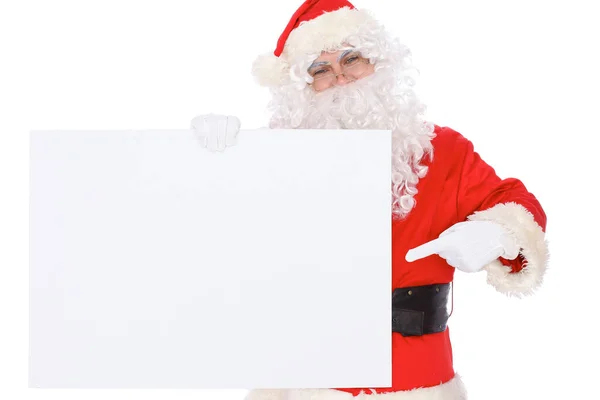 Santa Claus pointing on blank white wall, advertisement banner with copy space. Isolated on white background Royalty Free Stock Images