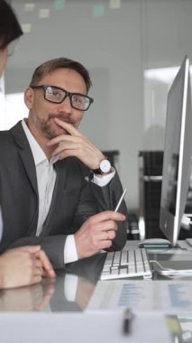 Profesyonel iş adamı ve meslektaşları el çırpıyor, şirket ofisinde yapılan bir iş toplantısında başarı, başarı ve olumlu sonuçlar için takdir ve coşku gösteriyorlar.