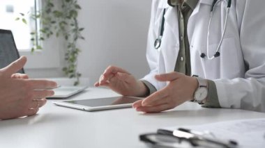 Dijital test sonuçlarını hastayla inceleyen kadın doktor, modern klinik ortamdaki tıbbi bulguları, sağlık teknolojisi etkileşimini tartışıyor. İlaç ve sağlık hizmetleri kavramı