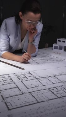 Mimar, el çizimi bir model ve aydınlatma masasındaki aletlerle mimari çizimlere derinden odaklanmıştır. Gösterişsiz ışıklandırmada mimari ve iş konsepti