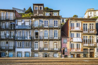 Tourist taking a photo of the traditional architecture of Porto, Portugal