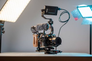 Full frame camera with external monitor, mic, and handheld film-making rig. clipart