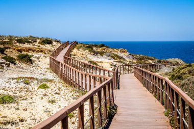 Wooden walkways by the Atlantic Ocean in Zambujeira Do Mar, Vicentina Coast Natural Park, Alentejo, Portugal clipart