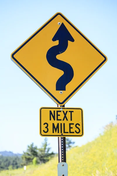 Winding road next 3 miles, road sign — Stock Photo, Image