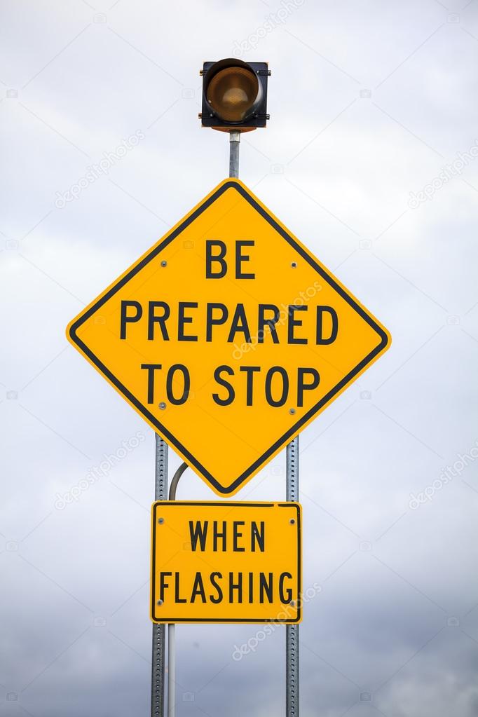 Be prepared to stop when flashing, road sign