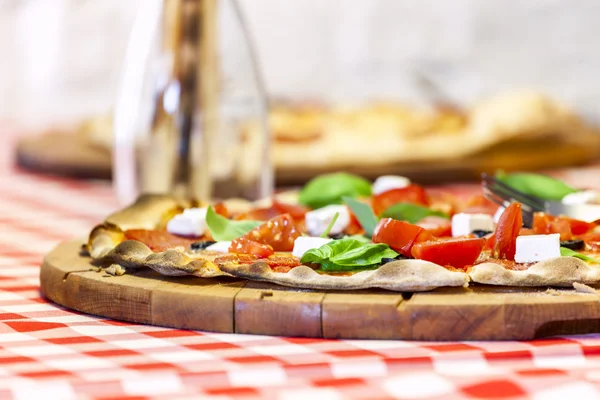 Delicious Italian pizza served on wooden board. — Stock Photo, Image