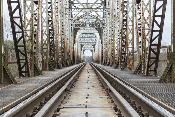 Railway trucks going through bridge — Stock Photo, Image