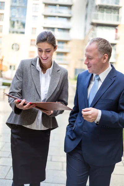 Twee mensen uit het bedrijfsleven bespreken buiten het kantoor — Stockfoto