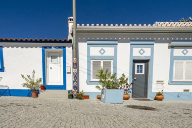 Vila Nova de Milfontes şehri, Alentejo sahili, Portekiz. Beyazlatılmış evler, kaldırım taşı sokaklar. Avrupa kıyı kenti, seyahat beldesi, Akdeniz mimarisi, yaz turizmi.