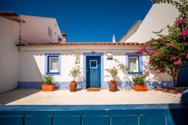 Vila Nova de Milfontes şehri, Alentejo sahili, Portekiz. Beyazlatılmış evler, kaldırım taşı sokaklar. Avrupa kıyı kenti, seyahat beldesi, Akdeniz mimarisi, yaz turizmi.