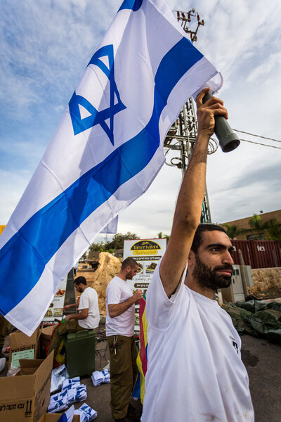 Israeli soldier with national flag