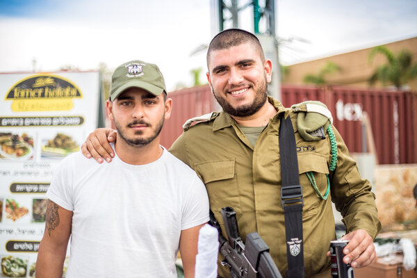 Two Israeli soldiers posing to the photo