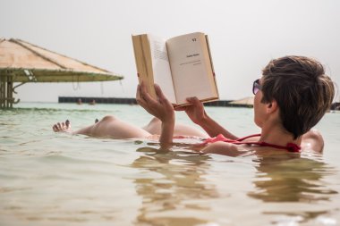 Genç kadın Dead Sea, İsrail için bir kitap okuma