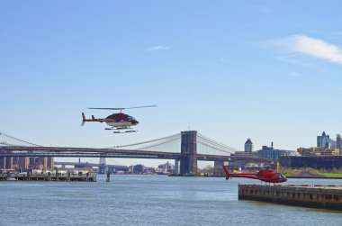 Brooklyn Köprüsü ve Manhattan Köprüsü üzerinden Doğu Nehri yakınındaki helikopter