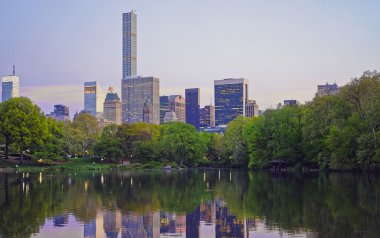 Midtown Manhattan siluetinin Central Park sudan yansıyan