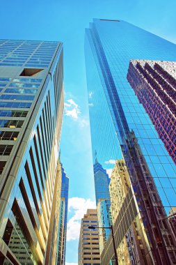 Bottom-up view to skyscrapers reflected in glass in Philadelphia clipart