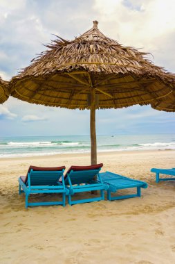 Shelter and sun beds in China Beach in Da Nang clipart