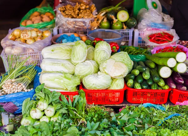 Asian street market selling cabbage cucumber zucchini and onion Stock Picture