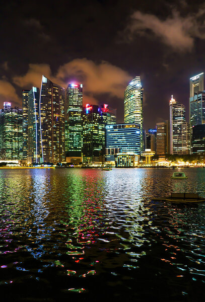 Singapore, Singapore - March 2, 2016: Singapore skyline of Downtown Core on Marina Bay at twilight. Cityscape of famous Skyscrapers illuminated with light and reflected in the water.