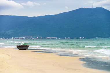 Bamboo fishing boat at China Beach in Danang in Vietnam clipart