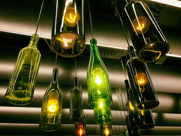 Beautiful retro light lamps decor made of wine bottles