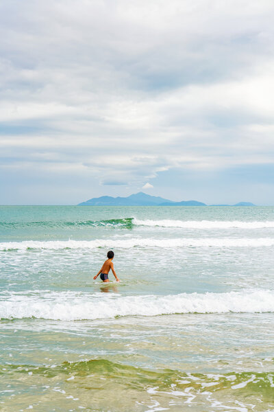 Boy swimming in the sea in Danang in Vietnam