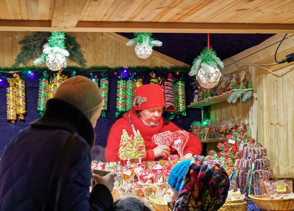 Seller and Stall with colorful candies at Vilnius Christmas Market — Stock Photo, Image