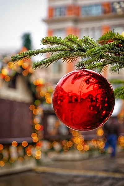 Red decorating ball on the christmas tree at the street market — Stock Photo, Image