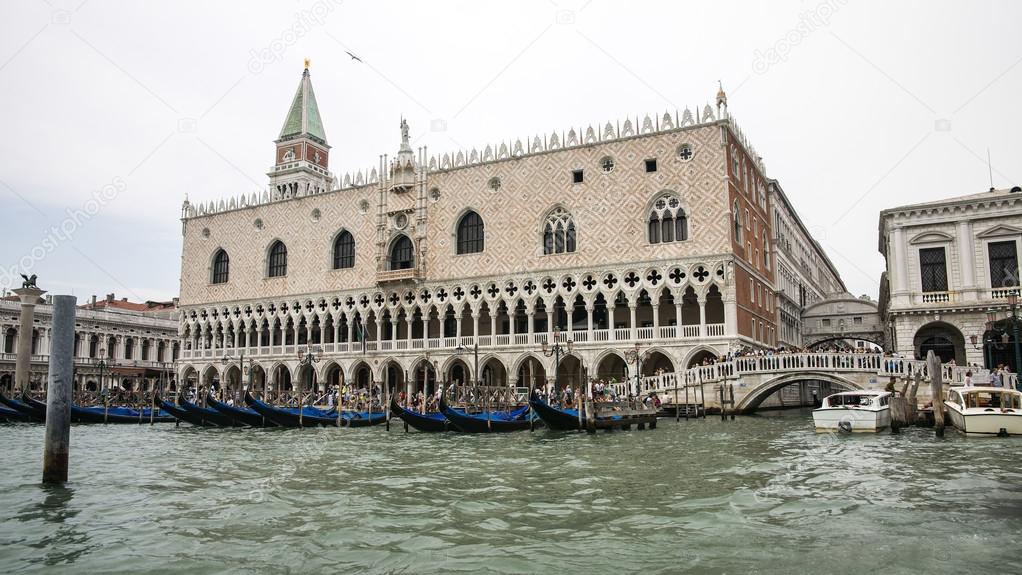 Gondolas parking near Doges palace in summer Venice