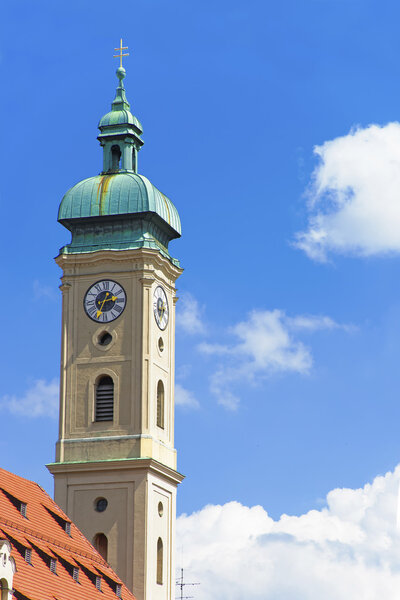 Clock tower of cathedral in Munich in front of blue skies