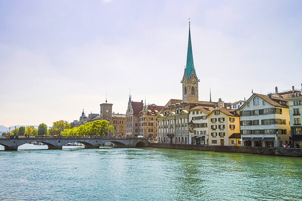 Zurich city center and Limmat quay in summer with city hall clock tower spire