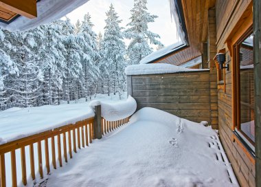 Cottage balcony covered with snow in Ruka in Finland in the Arctic clipart