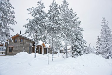 Cottages covered with snow in Ruka in Finland on the Arctic pole circle clipart