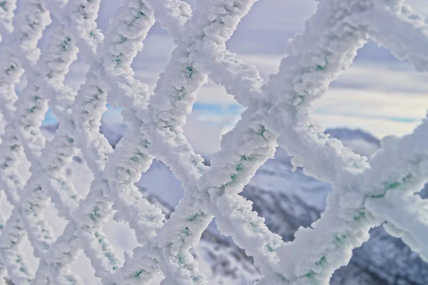 Fencing mesh being frozen in mountains in winter