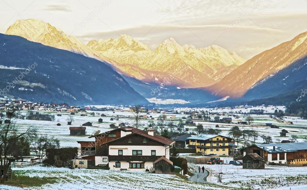 View of countryside in snow covered Switzerland at sunset