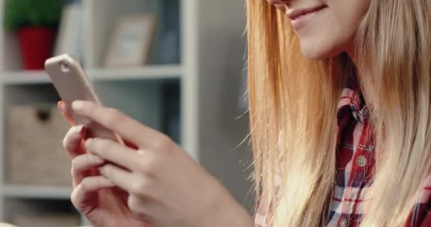Крупный план портрета молодой женщины-пользователя смартфона, проводящей свободное время с устройством в поисках информации в Интернете. — стоковое видео