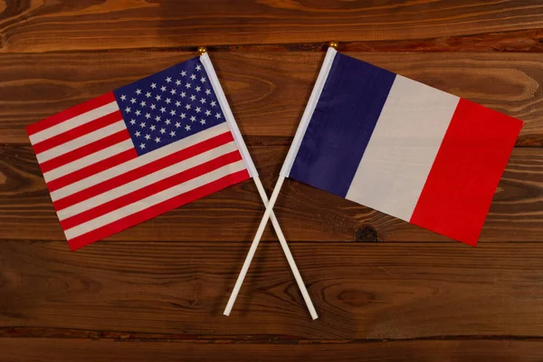 Flag of USA and flag of France crossed with each other. USA vs France. The image illustrates the relationship between countries. Photography for video news on TV and articles on the Internet and media.