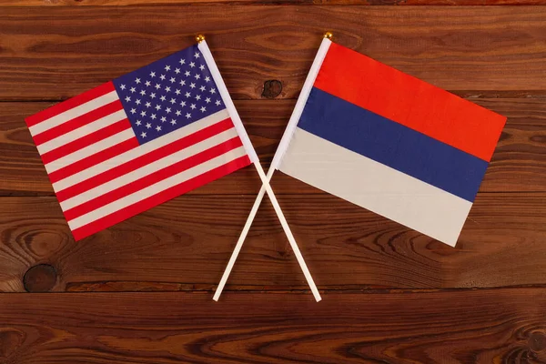 USA flag and Russia flag crossed with each other. USA vs Russia. Meeting between the presidents of the United States and Russia. Tensions in relations between the countries are growing