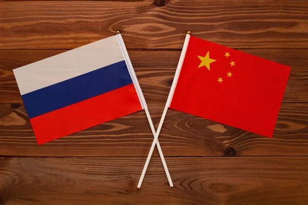 Flag of Russia and flag of China crossed with each other. The image illustrates the relationship between countries. Photography for video news on TV and articles on the Internet and media.