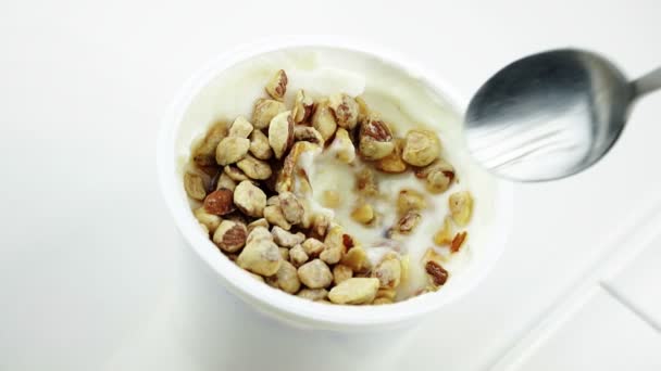 Close-up of healthy cereal and chocolate and white yogurt on the spoon — Stock Video