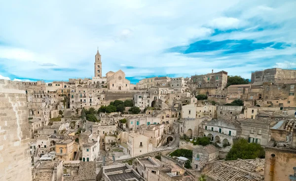 Panoramic view of typical stones (Sassi di Matera) and church of Matera under blue sky — Stock Photo, Image