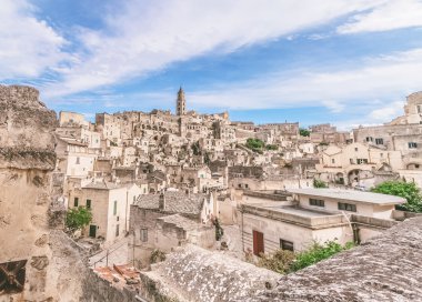 panoramik tipik taşlar (Sassi di Matera) ve kilise Matera mavi gökyüzü altında