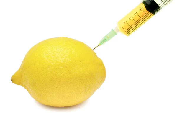 Medical injection with liquid and a yellow lemon — Stock Photo, Image