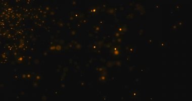 Altın parçacıkları, siyah arka planda parıldayan bokeh ışıltıları, yeni yıl tatilleri