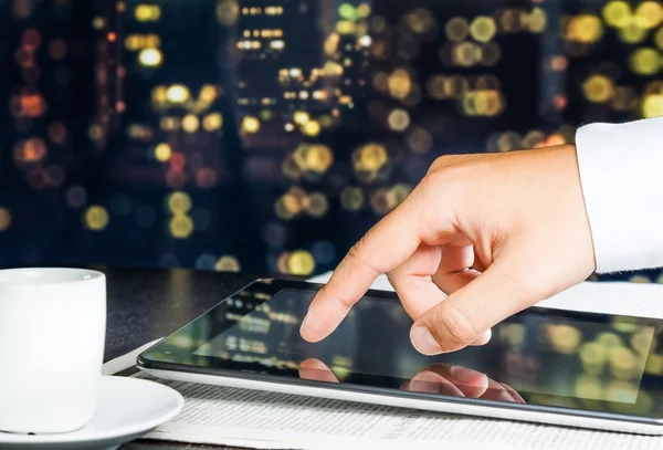 Business man touch digital tablet on business newspaper — Stock Photo, Image